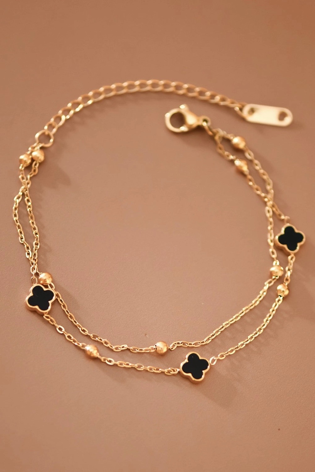 Double-layer gold chain bracelet with black clover charms