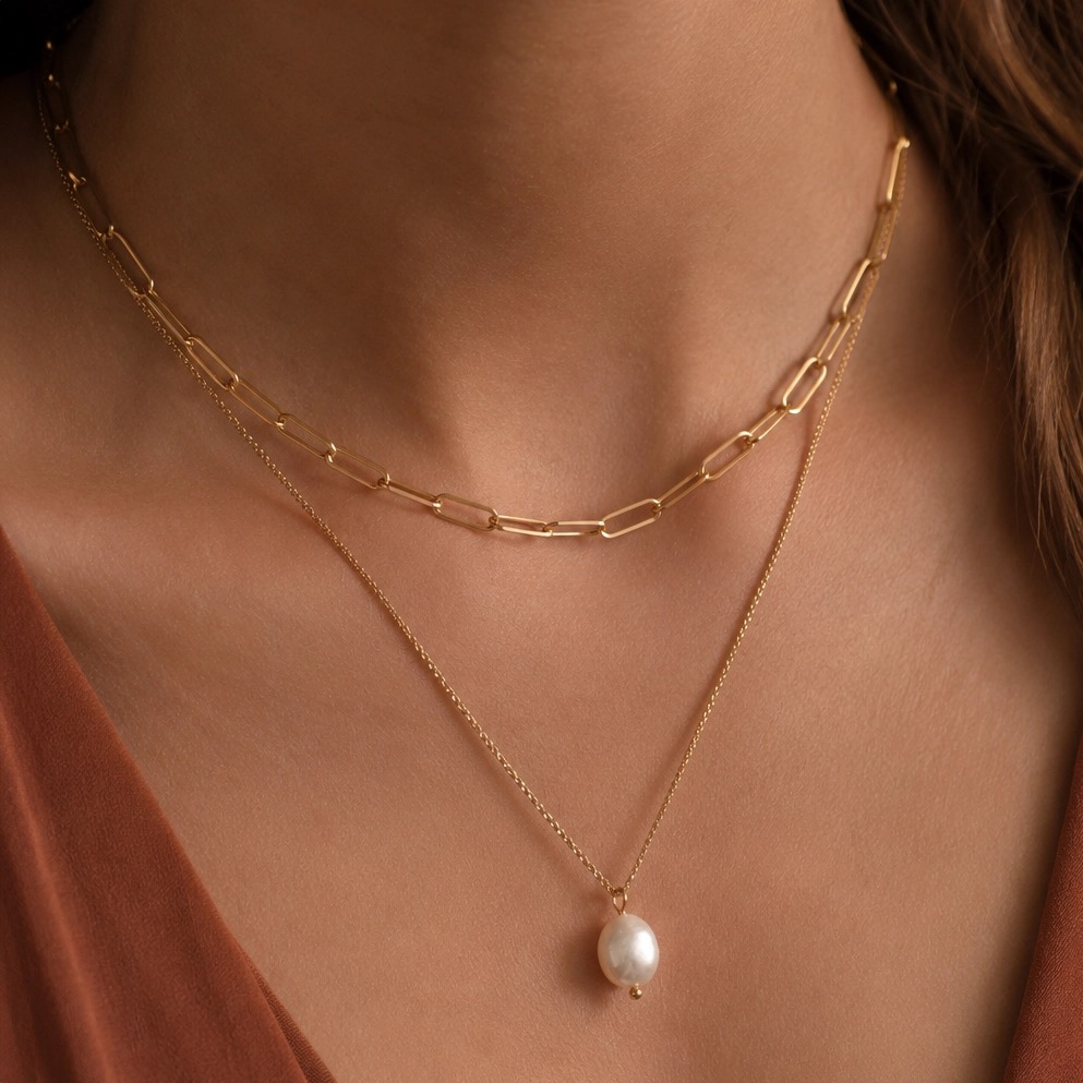 Gold paperclip chain layered with a baroque pearl pendant necklace